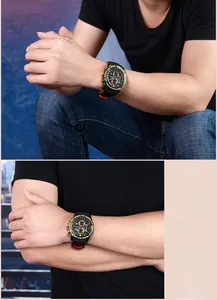 Close-up of a men's chronograph watch featuring a black dial and red silicone strap