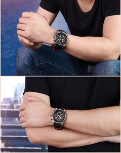 Detail of masculine sports watch with black silicone strap and red accent details