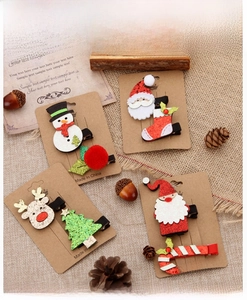 Christmas hair clip set featuring Santa and Reindeer designs on a rustic burlap background