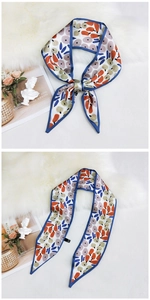 Detail of a white silk twilly scarf with abstract fruit print and dark blue edges