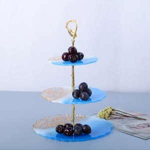 Detailed view of a 3-tier blue resin fruit tray with gold foil edges and branch stand