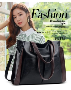 Fashion black leather tote bag with brown handles and adjustable shoulder strap shown on model