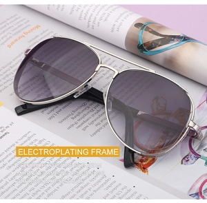 Detail of silver electroplated frame and smoky gray gradient lenses on pilot sunglasses