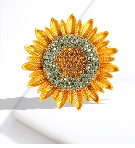 Detailed view of luxury sunflower brooch with sparkling rhinestones on golden petals