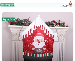 Detailed view of Santa Claus chair cover with Warm Wishes sign and snow-top design