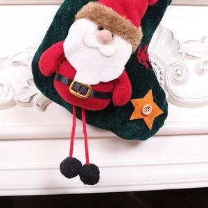 Green velvet Christmas stocking with plush Santa Claus and star detail decoration