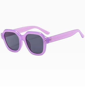 Detail of purple translucent square frames and metal rivet accents on chic sunglasses