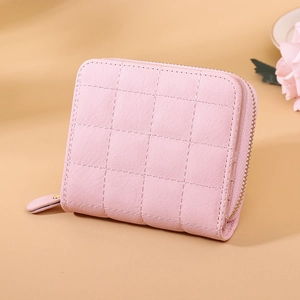 Close-up of pink quilted PU leather wallet with metallic zipper and elegant texture