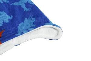 Detail of blue dinosaur jacquard knit with thick white fleece lining for warmth