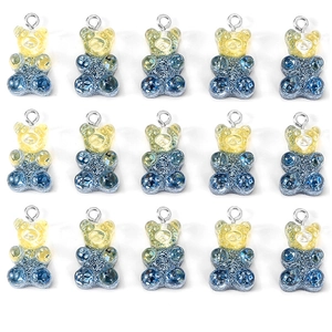 Macro view of fifteen resin gummy bear pendants with yellow-blue gradient and glitter