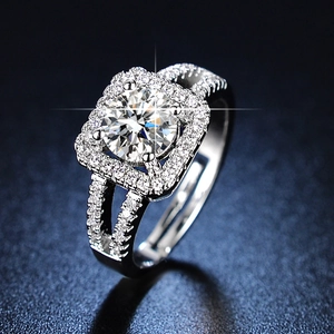 Macro shot of silver six-prong cubic zirconia ring with sparkling pavé set diamonds