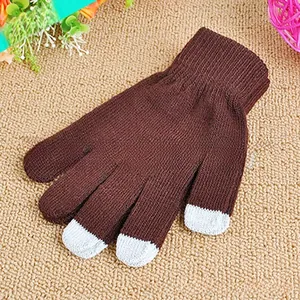 Close-up of thick knitted winter gloves in dark brown with grey touchscreen fingertips
