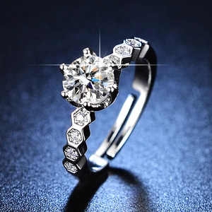 Macro shot of six-prong moissanite ring with unique hexagonal honeycomb side details