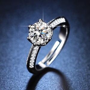 Macro shot of silver six-prong round cut simulated diamond ring with side accent stones
