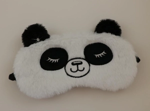 Detailed view of plush panda sleep mask featuring embroidered eyelashes and soft 3D ears