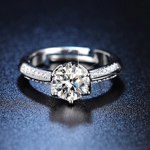 Detailed view of 1 carat six-prong diamond ring with sparkling side stones and open band