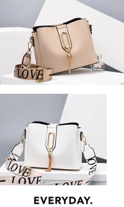 Detail of trendy bucket bag showing leather texture, metal ring, and tassel ornament