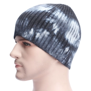 Gros plan du bonnet en tricot tie-dye montrant la texture côtelée en coton noir et blanc