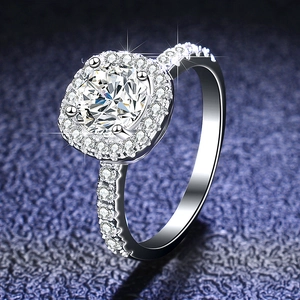 Macro shot of 1 carat round moissanite ring with halo setting and pavé side stones