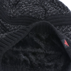 Detail of warm winter knit hat with thick black fleece lining and snowflake tag