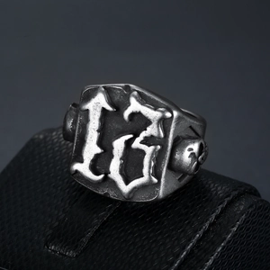 Gothic retro silver ring featuring number 13 and skull relief on a textured stand