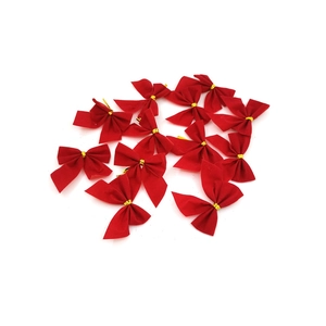 Close-up of red fabric Christmas bows with gold wire ties for holiday gift decoration