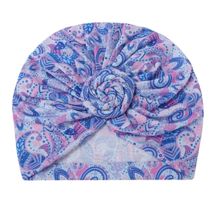 Infant paisley print turban hat with stylish spiral knot design in vibrant multicolor fabric