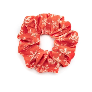 Red Christmas velvet scrunchie with white snowflake patterns for holiday hairstyling