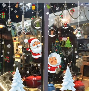 Detail showing Santa Claus and reindeer Christmas window stickers on glass storefront