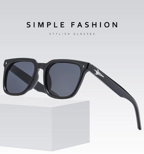 Detail of square black sunglasses with silver star metal ornaments on the temples