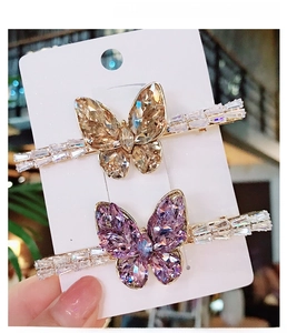Detail of copper hair clips featuring zircon and K9 crystal butterflies in gold and purple