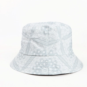 Detail shot of light blue paisley bucket hat featuring intricate white floral patterns