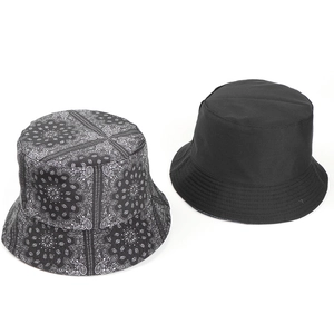 Detail view of double-sided paisley print and solid black cotton canvas bucket hat set