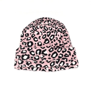 Detail of pink leopard print knit beanie featuring a wide ribbed cuff for winter warmth