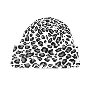 Close-up of leopard print knit beanie featuring premium thick texture and folded cuff