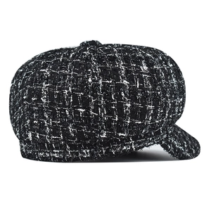 Detail of black and white tweed newsboy cap with subtle sequins and vintage texture