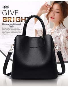 Detail of classic black lychee grain leather bucket bag with metallic ring and strap