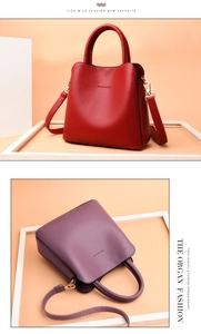 Close-up of red and purple bucket bags with pebbled leather and golden hardware