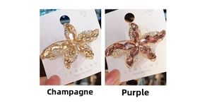 Detailed close-up of K9 crystal starfish hair clips in champagne and purple colors