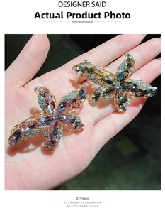 Detailed view of floral hair clips set with sparkling purple and grey zircon crystals