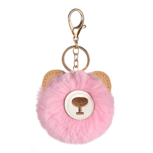Pink faux rabbit fur teddy bear keychain with golden clasp on white background