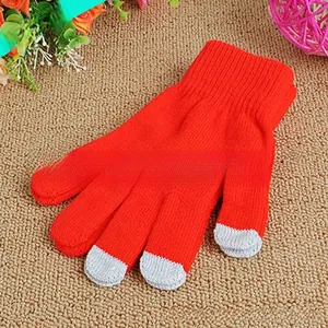 Close-up of red touchscreen knitted gloves with gray conductive tips for winter warmth