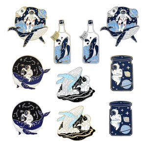 Cute astronaut and whale enamel pins featuring cosmic dream and sea exploration designs