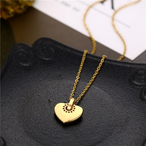 18K gold heart-shaped titanium necklace with shell inlay and gear-shaped pendant bail
