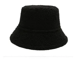 Detail of black faux fur bucket hat showing plush curly lambwool texture for winter
