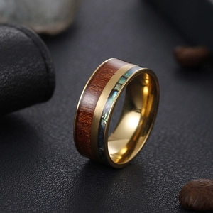 Macro detail of 9mm titanium steel ring featuring koa wood and abalone shell inlay