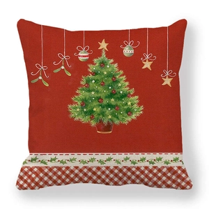 Detail of red Christmas tree linen pillowcase with festive holly and plaid patterns