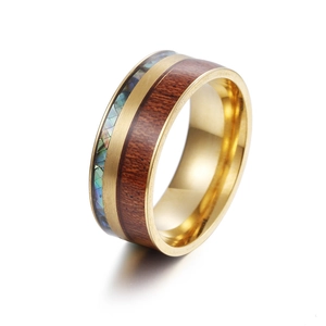 Macro shot of 9MM titanium steel ring featuring koa wood and abalone shell inlay detail