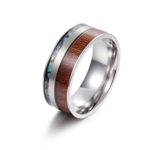 Close-up of 9mm titanium ring with koa wood inlay and abalone shell fragments