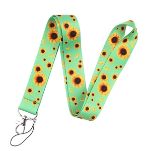 Detail of green lanyard featuring yellow sunflower patterns with a metal lobster clasp